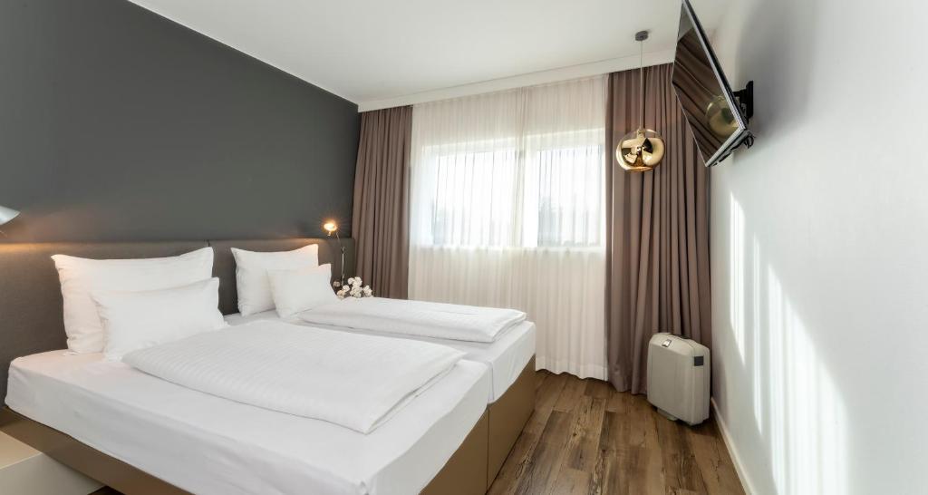 Cama o camas de una habitación en PLAZA INN Graz