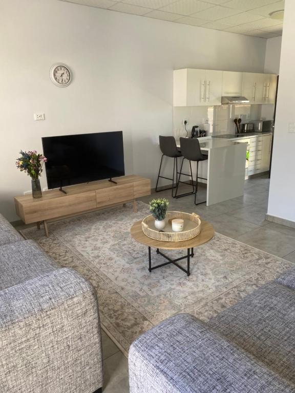 a living room with a tv and a table at Sunbird self-catering B in Windhoek