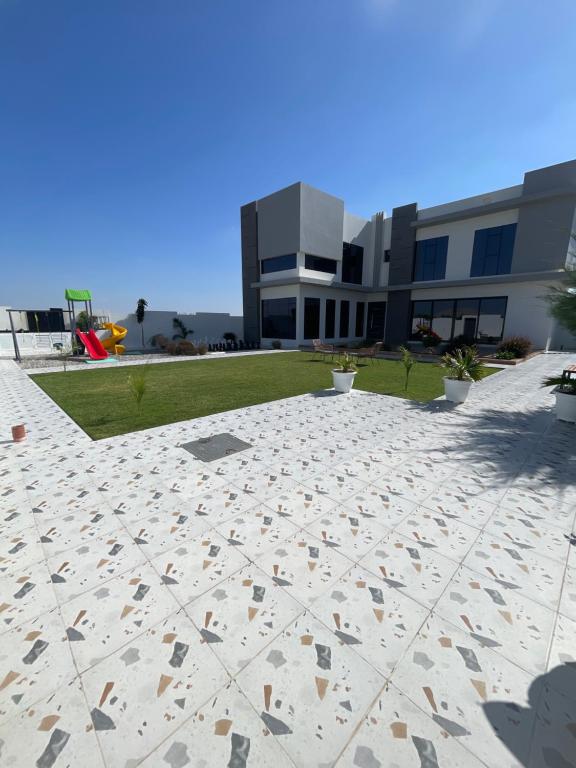 a view of a building with a concrete patio at calm chalet گالم شالية in Ţaymissah