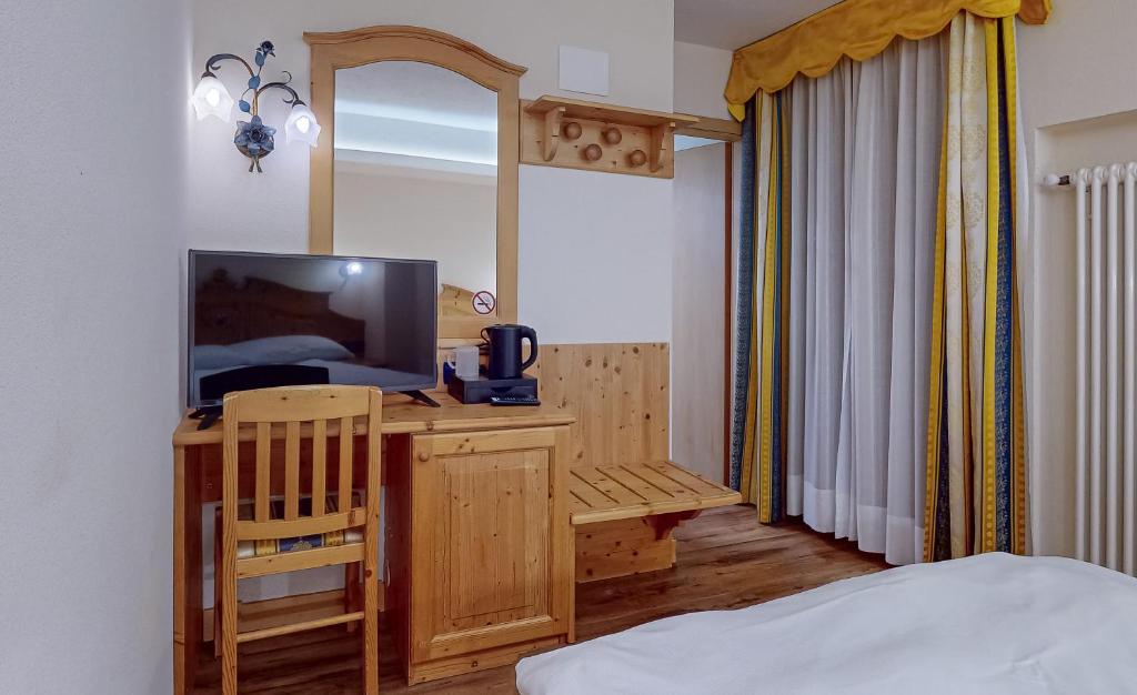 Postel nebo postele na pokoji v ubytování Hotel Madonna delle Nevi