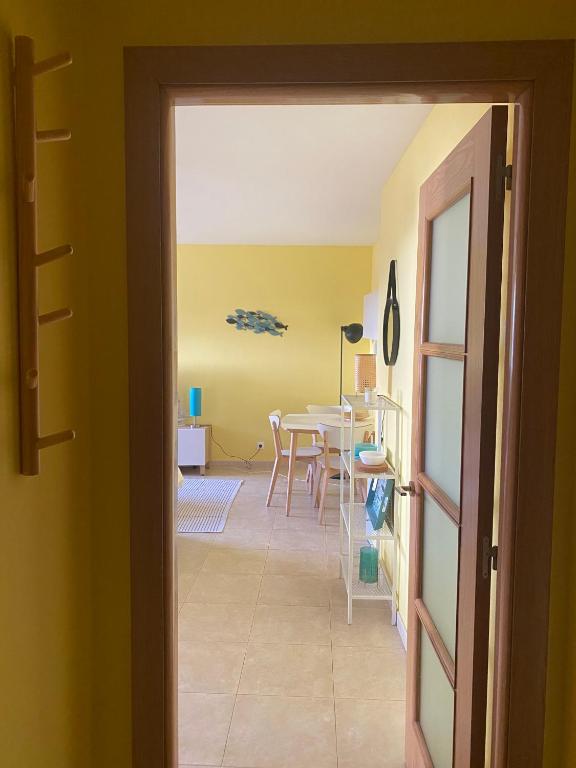 a room with a table and a dining room at Acogedor apartamento con terraza in Cedeira
