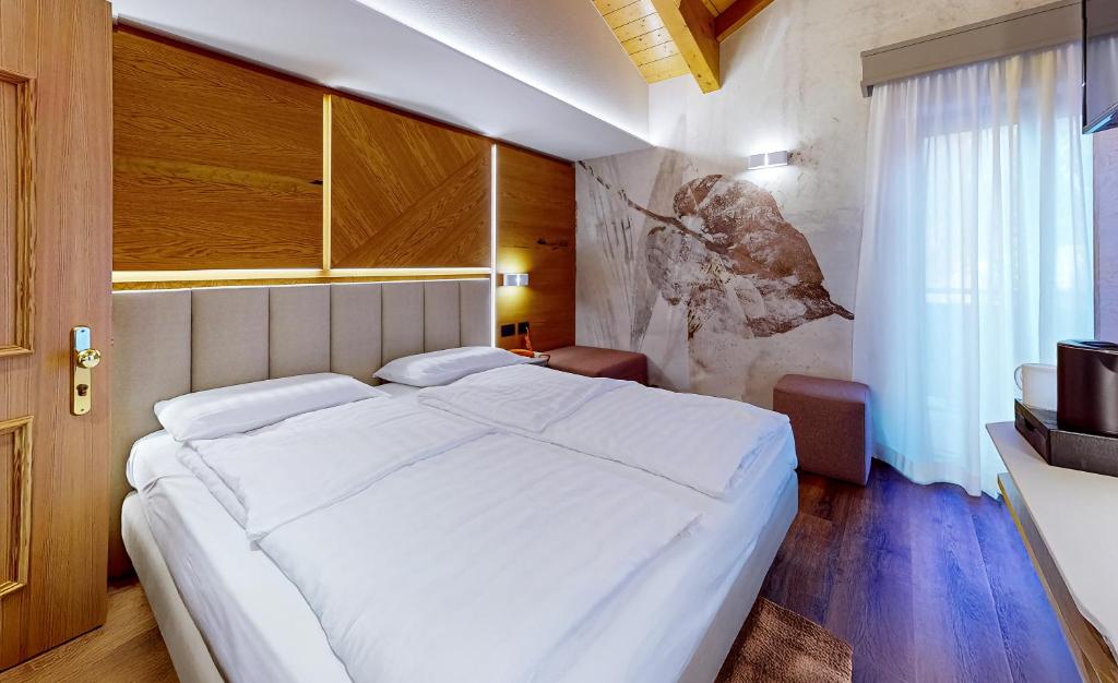 Postel nebo postele na pokoji v ubytování Hotel Madonna delle Nevi