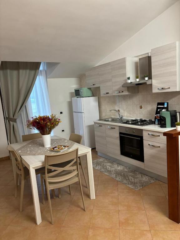 a kitchen with a table and a kitchen with a sink at Del Golfo House in Angri