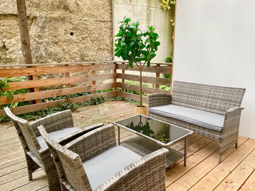 a patio with two chairs and a table and a plant at Cosy Apartment with Terrace & Free Parking in Vienna