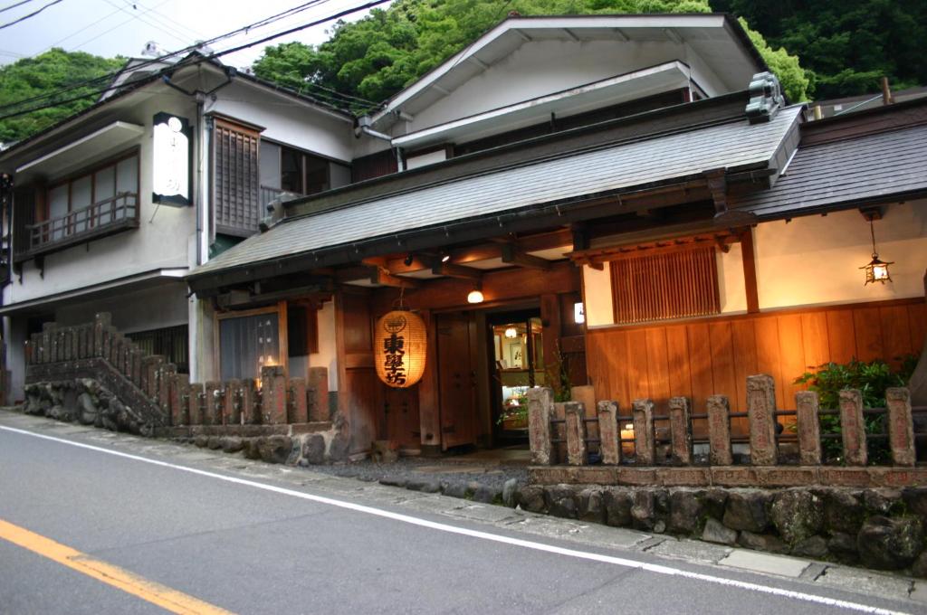 a building with a fence in front of a street at Togakubo in Isehara