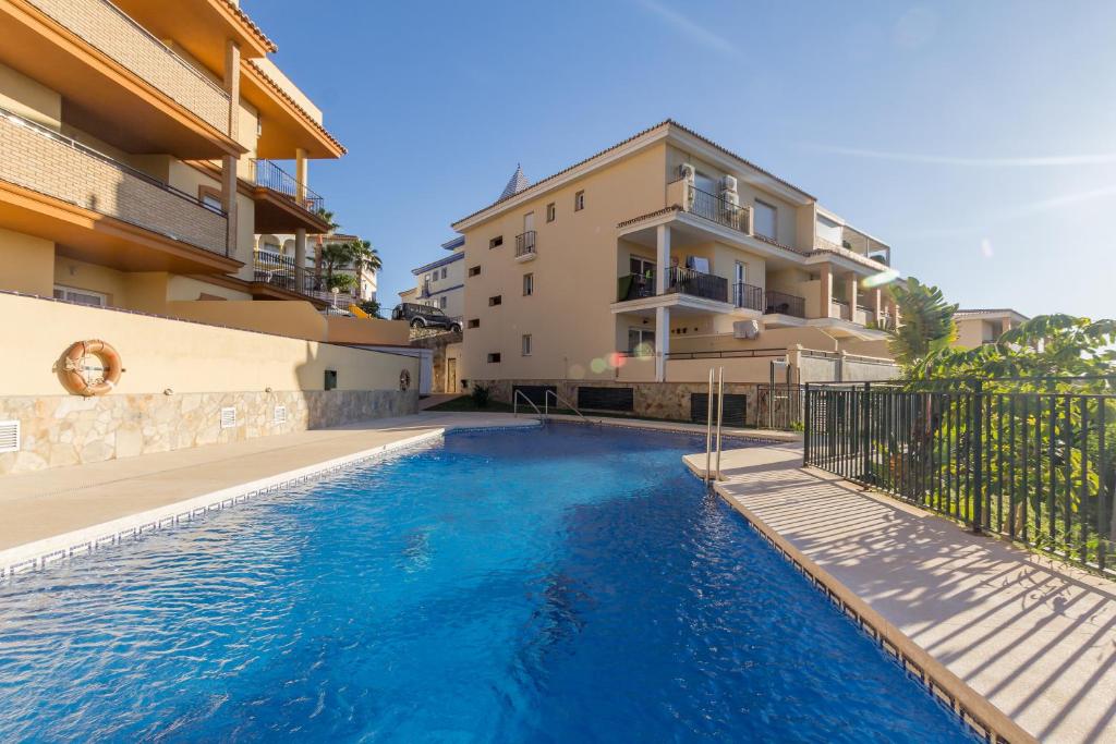 a swimming pool in front of a building at Winter Deal - Luxury Apartment with Terrace Mountain Views Near Beach in Fuengirola