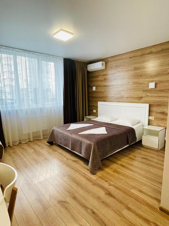 a bedroom with a bed and a wooden wall at East Residence in Kyiv