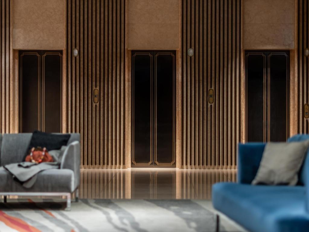 a living room with two chairs and a couch at Mitsui Garden Hotel Hiroshima in Hiroshima