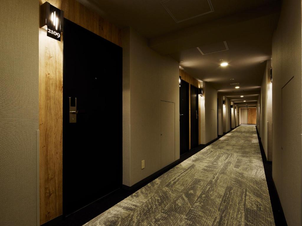an empty hallway with a sign on the wall at Mitsui Garden Hotel Hiroshima in Hiroshima