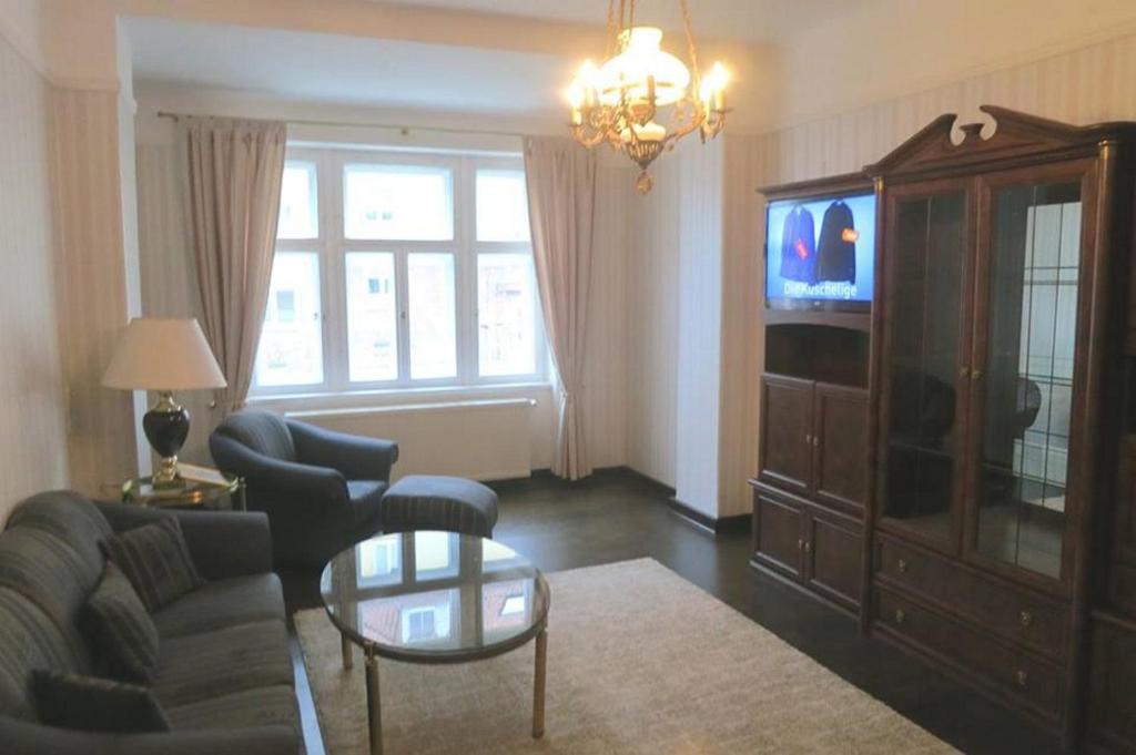 a living room with a couch and a tv at DD-Rent Dresden Apartment in Dresden