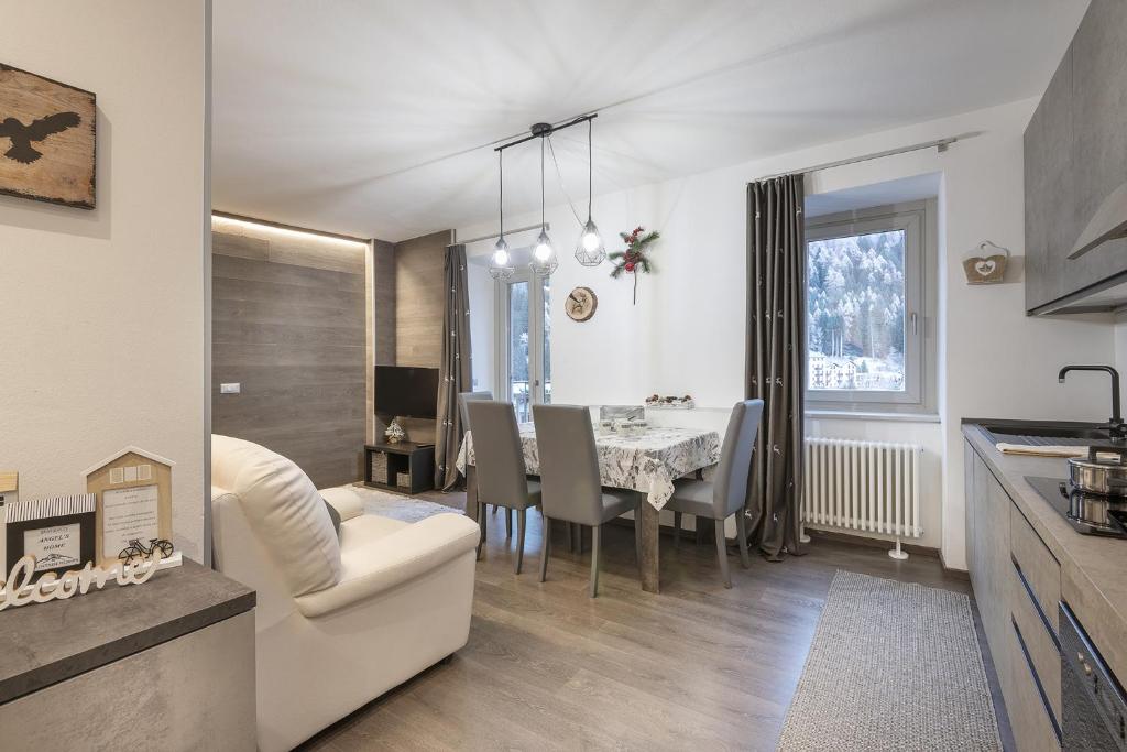 a kitchen and dining room with a table and chairs at Angel's Home 1 in Ponte di Legno