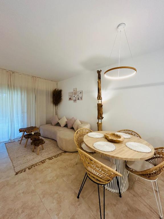 a living room with a table and a couch at Zen Garden Apartment in Vera