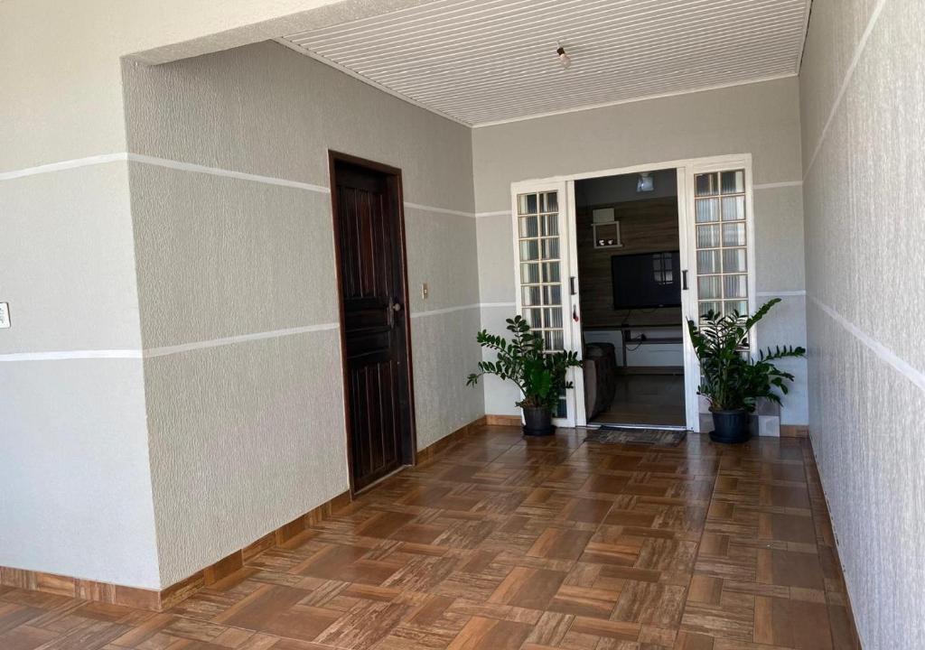 an empty room with a wooden floor and a door at Casa Gil in Foz do Iguaçu