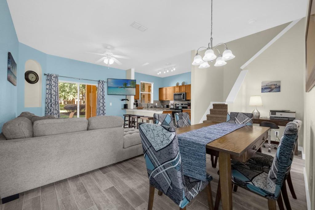 a living room with a couch and a table and chairs at Lazy River Resort Townhome in Davenport