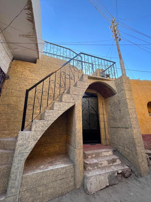 a set of stairs leading to a building with a gate at Hashem Nubian Guest House in Aswan