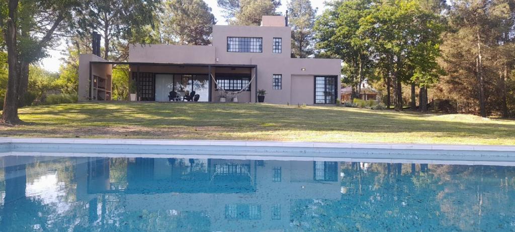 a house with a swimming pool in front of it at Punta Molinos in La Estancia