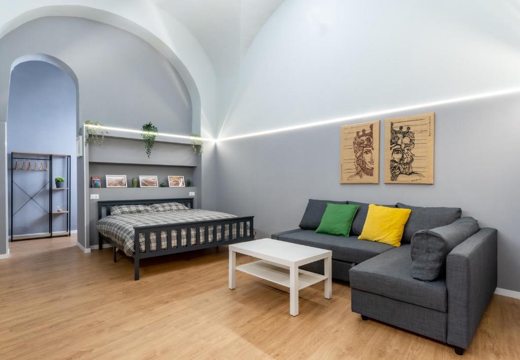 a living room with a couch and a table at Elephant and Castle - Exclusive Holiday Home in Catania