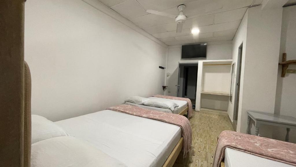 Postel nebo postele na pokoji v ubytování Hotel Balcon de Oro Curumani