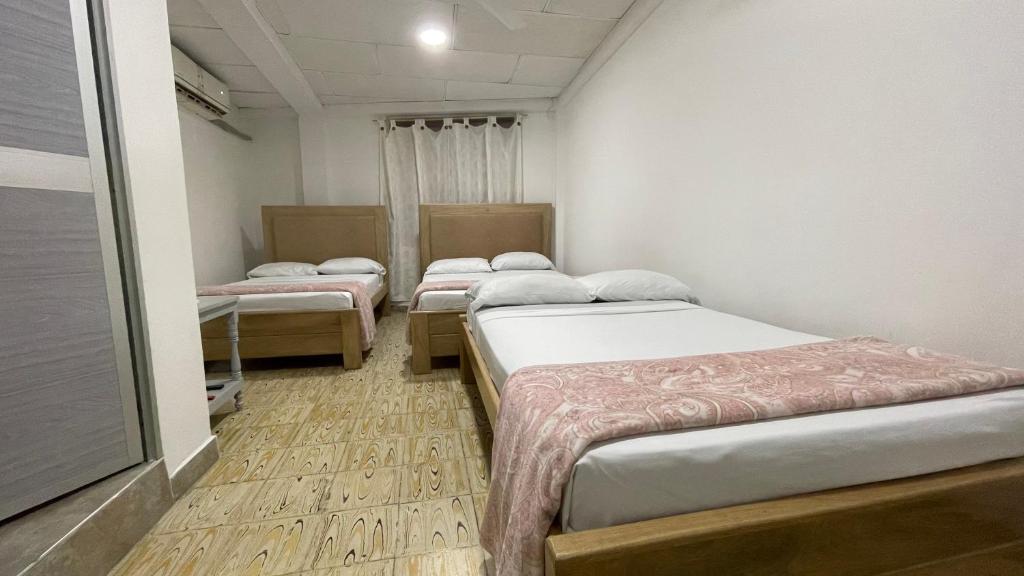 Postel nebo postele na pokoji v ubytování Hotel Balcon de Oro Curumani