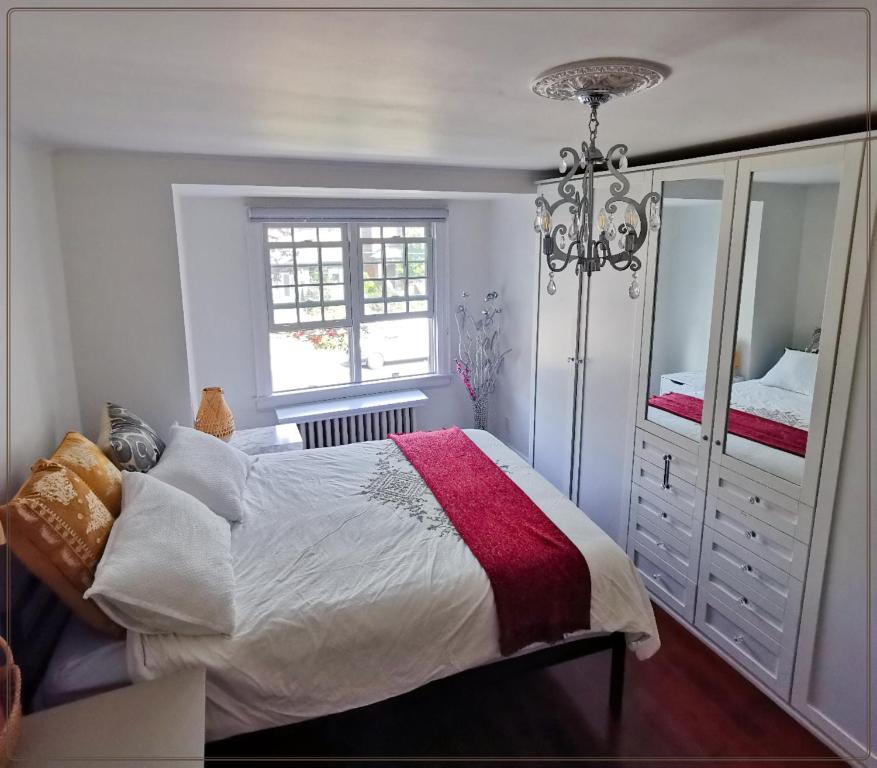 a bedroom with a bed and a dresser and a window at Cozy room with private bathroom near subway in Toronto