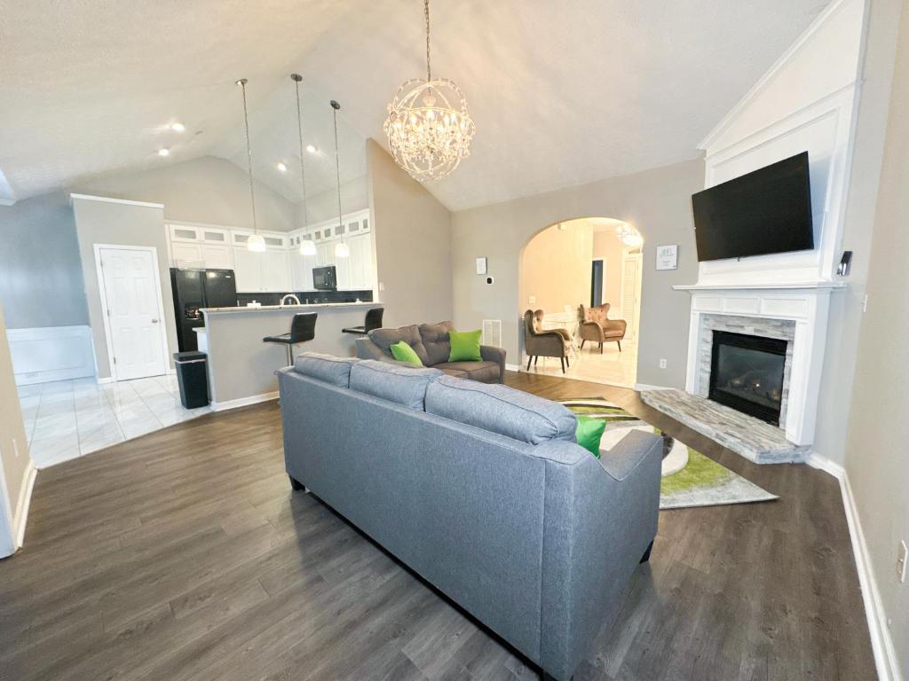 a living room with a blue couch and a fireplace at Cozy 3BR Home Near ATL Airport in Fairburn
