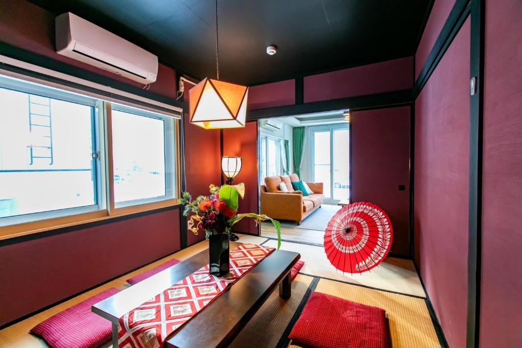 a living room with a bench and a red wall at THE SUNLIGHT in Sapporo