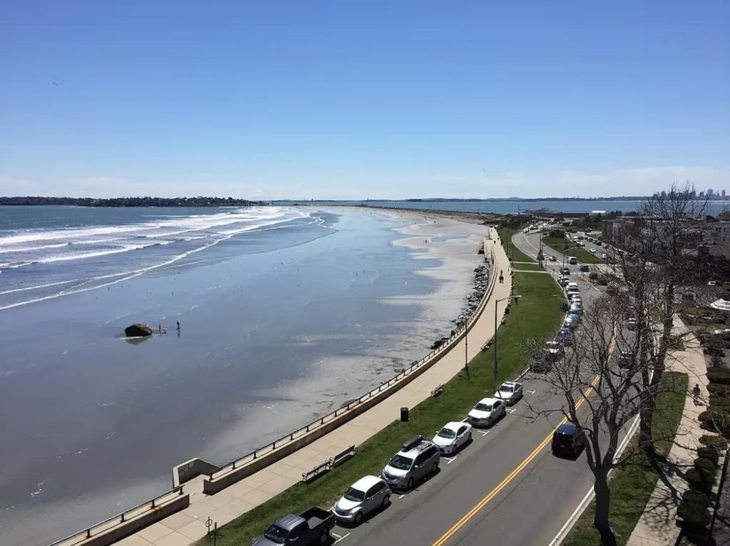 a view of a beach with cars parked at Queen Bed Condo by the Beach in Lynn