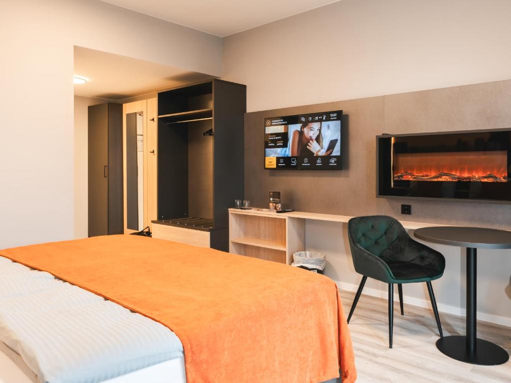 TV a/nebo společenská místnost v ubytování JustStay München Hotel & Apartments