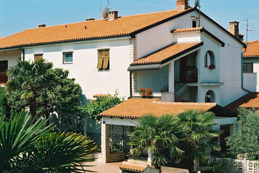 a large white house with orange roofs at House Monika in Poreč