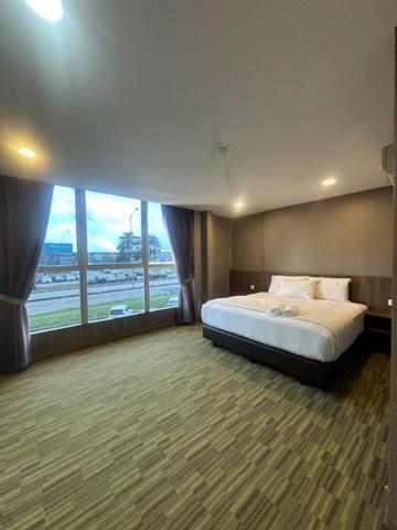 Postel nebo postele na pokoji v ubytování Li Garden Hotel