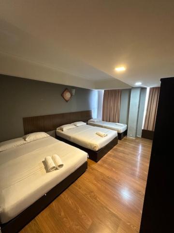 Postel nebo postele na pokoji v ubytování Li Garden Hotel
