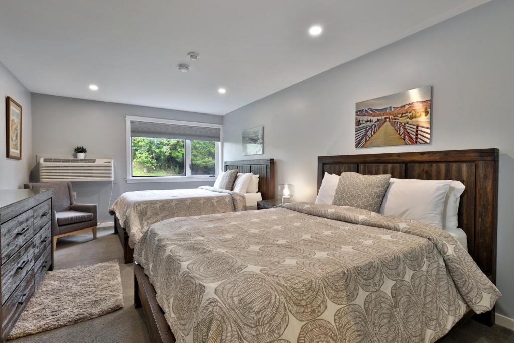 a large bedroom with two beds and a window at Ski Condo Close to the Resort, Shuttle Bus Route, Summer Pool, 2 Queen Beds in Killington