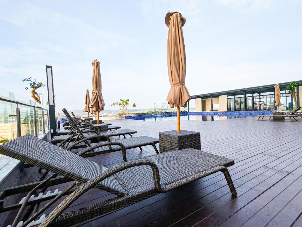 a group of tables and umbrellas on a patio at Lovina 806 at Pollux Meisterstadt in Batam Center