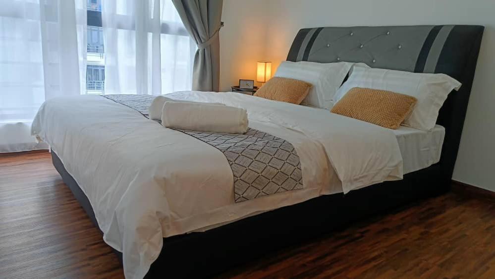 a large bed in a bedroom with a large window at D'Bayu Homestay in Donggongon