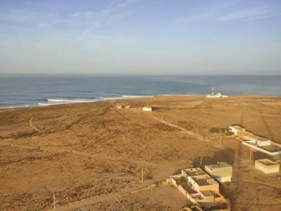 an aerial view of a beach with the ocean at EL Faro Surfstay in Tamri