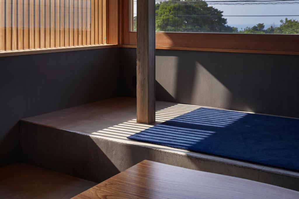 Postel nebo postele na pokoji v ubytování GOTO island ROKGOUTEI五島列島福江島のモダンな一棟貸ヴィラ