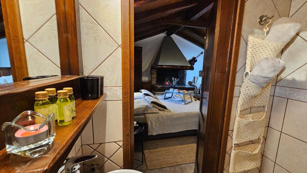 a bathroom mirror with a view of a bedroom at Studio apartment Cami - Cottage with a soul in Gračišće