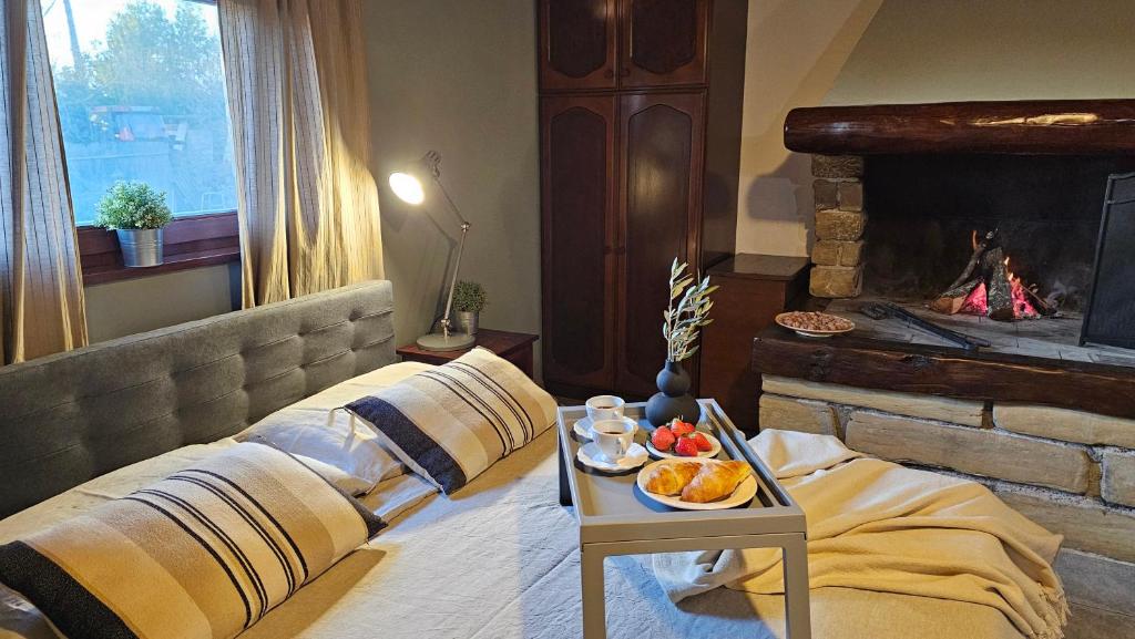 a bedroom with a bed with a table with food on it at Studio apartment Cami - Cottage with a soul in Gračišće