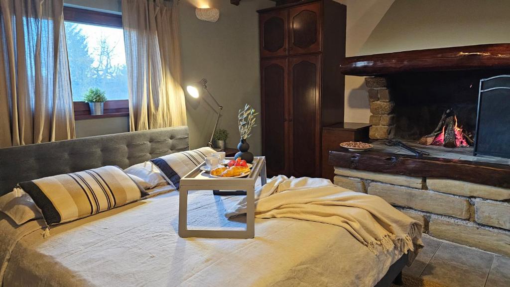 a bedroom with a bed with a table on it at Studio apartment Cami - Cottage with a soul in Gračišće
