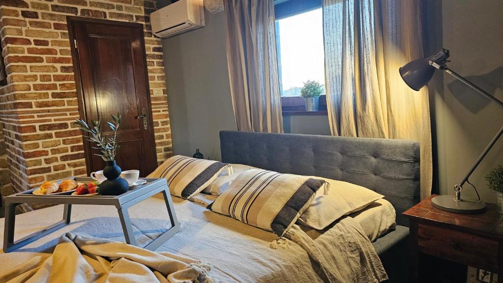 a bedroom with a bed and a table with fruit on it at Studio apartment Cami - Cottage with a soul in Gračišće