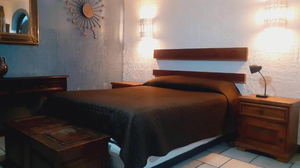 Voodi või voodid majutusasutuse Aparta-Hotel CASA REAL Apartamentos toas