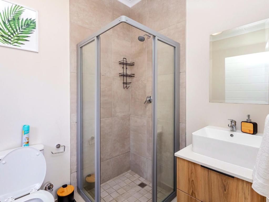 a bathroom with a shower and a sink at Sunset Haven in Midrand