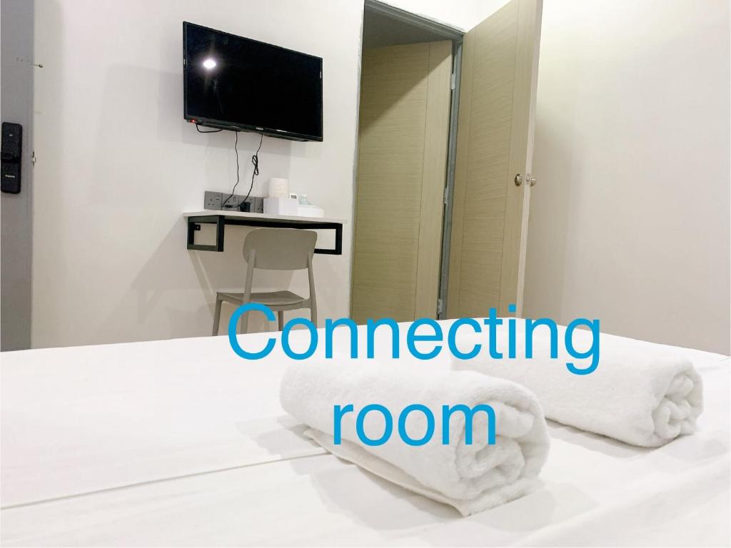 Postel nebo postele na pokoji v ubytování One Stop Hotel Ipoh