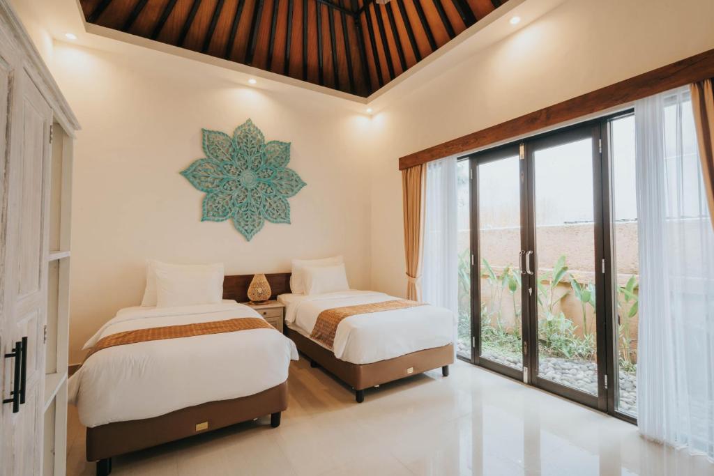 Postel nebo postele na pokoji v ubytování Alam Penari Resort Ubud