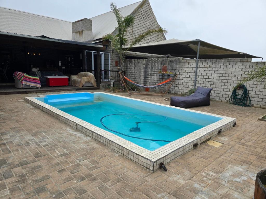 a large blue swimming pool in a yard at 6 Segal Close in Velddrif