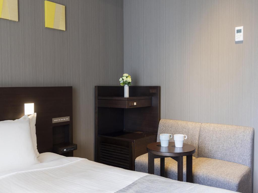 Postel nebo postele na pokoji v ubytování Akihabara Washington Hotel