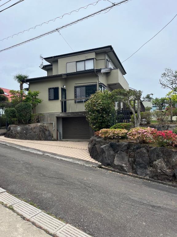 a house sitting on the side of a street at I Love Izu in Futo