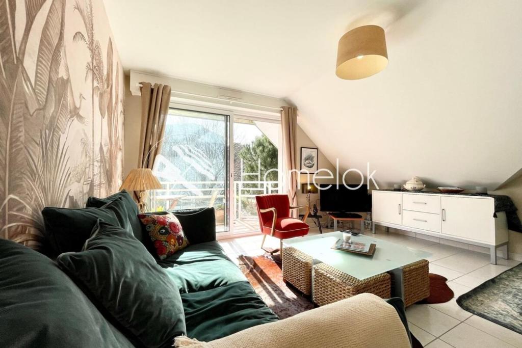 a living room with a couch and a table at T2 Top Cosy Balcon 150m des plages in Carnac