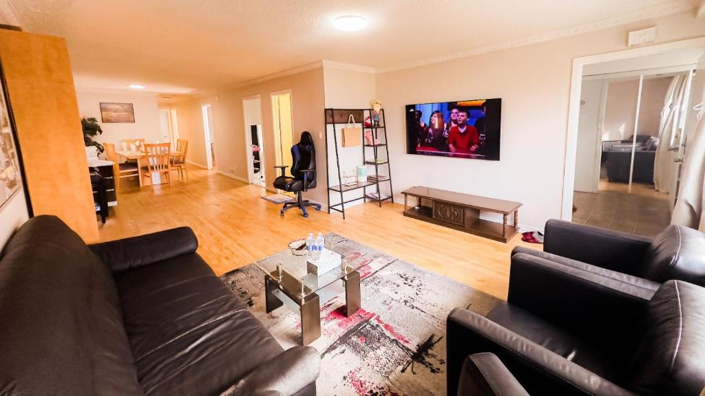 a living room with a couch and a table at Full Privacy Apartment with Free Parkrings in Toronto