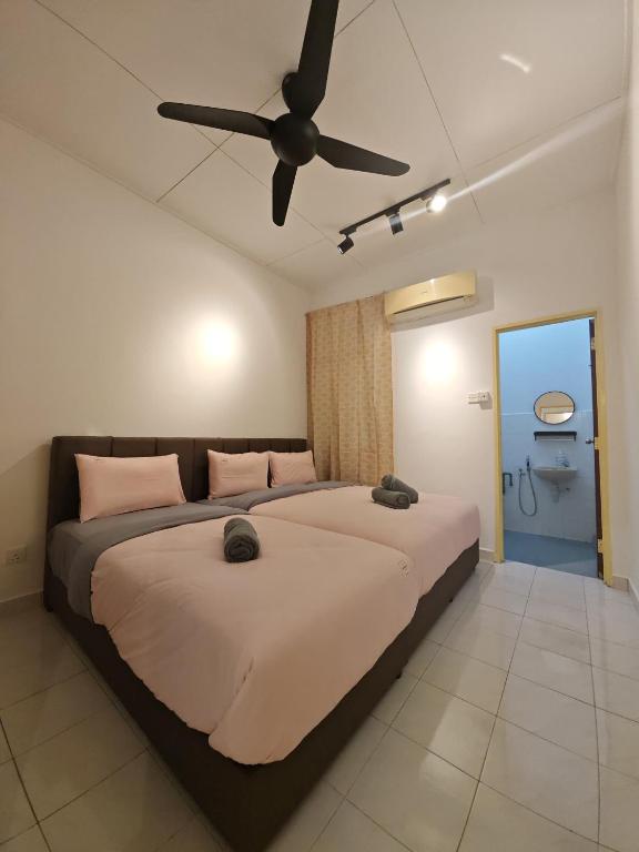 Un dormitorio con dos camas y un ventilador de techo. en Garden Homes Seremban 2 644, en Seremban